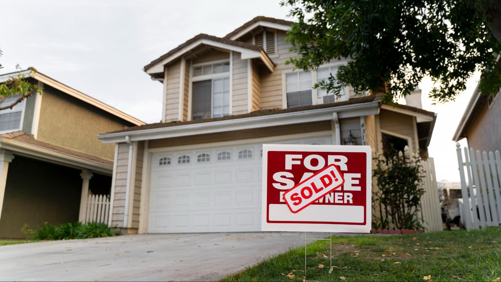 A house with a sold sign on the front.