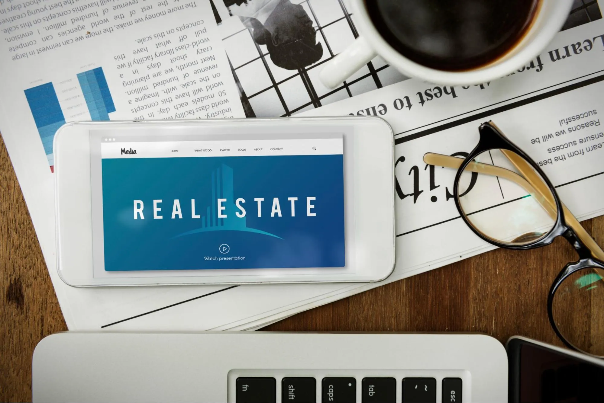 Real Estate Website on Phone Screen With Newspaper in Background.