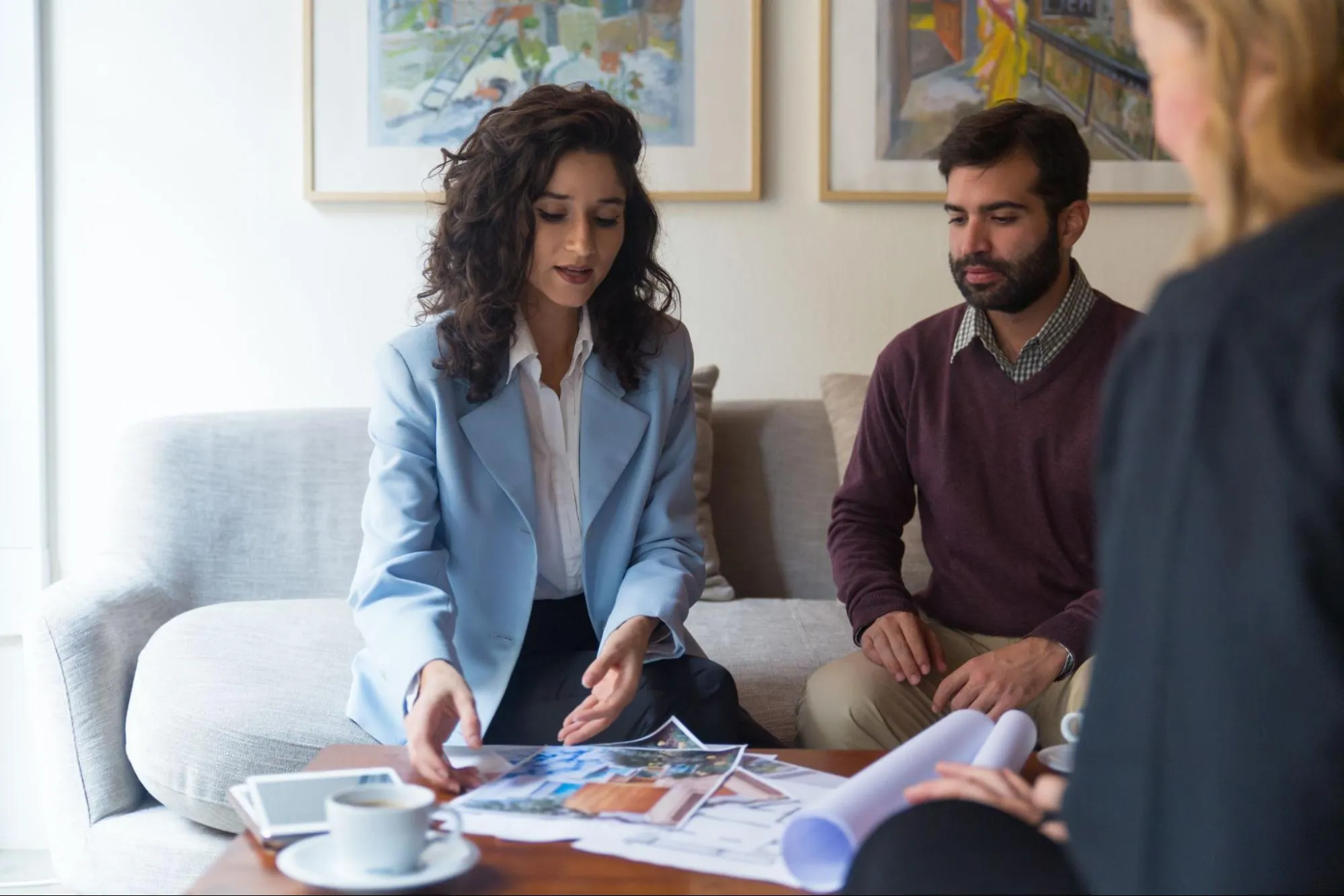 A couple talking to a professional about real estate investment.