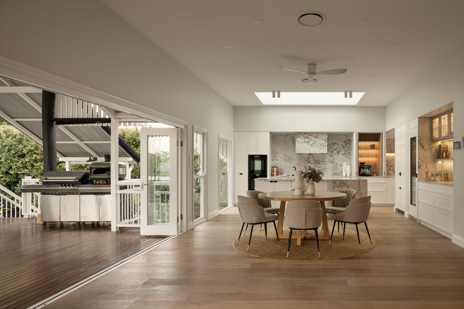View of dining, kitchen and indoor outdoor living with a view of the deck