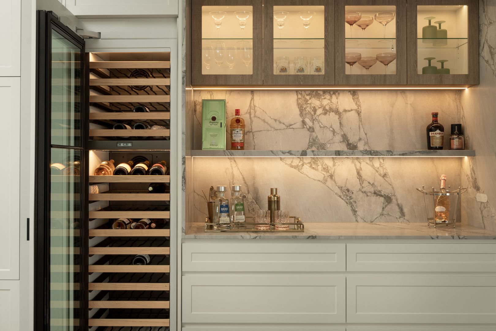 Bar with wine fridge, open shelves and glass front cabinets 