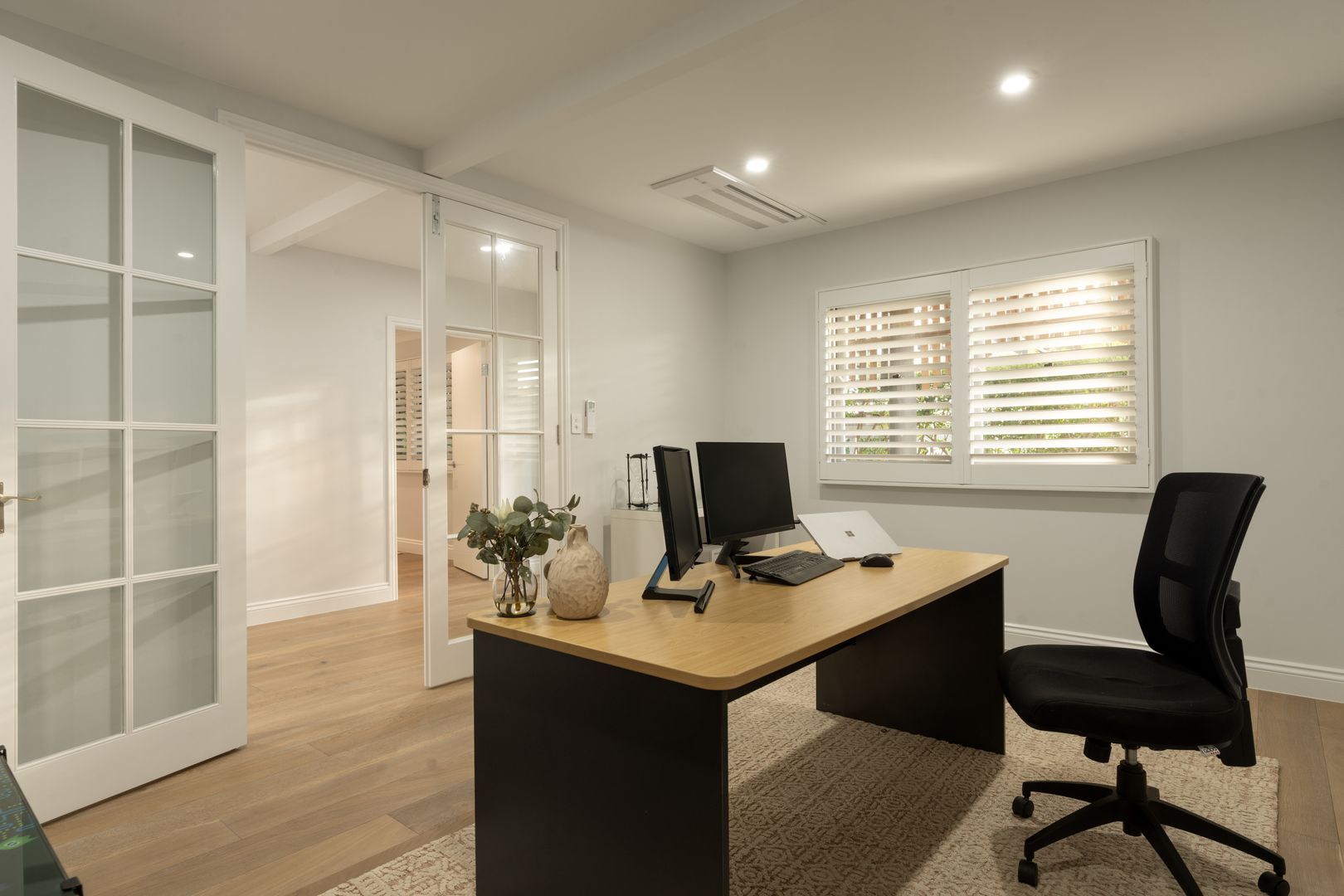 Office with desk and chair in the middle of the room