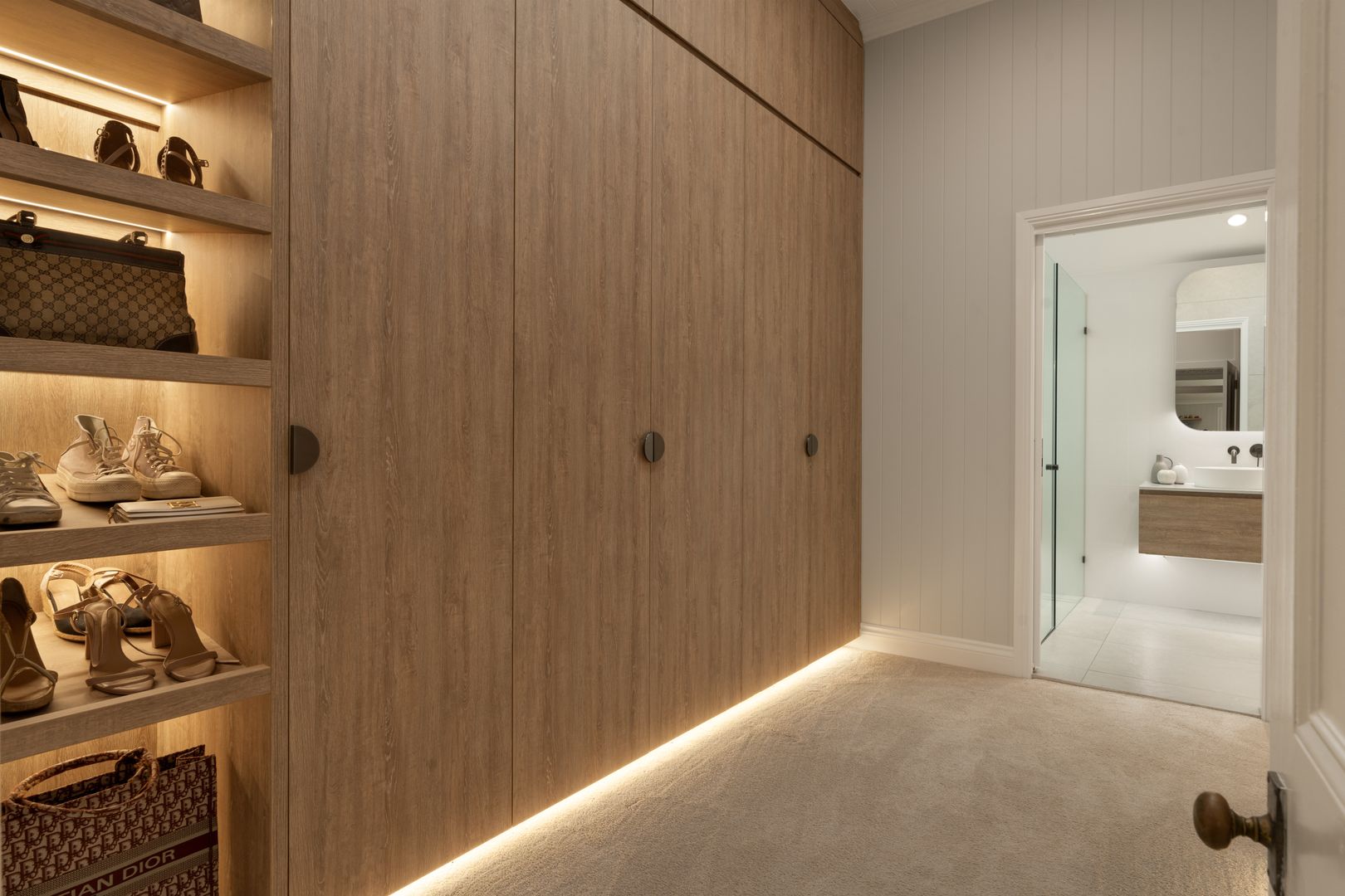 Walk in robe with closed custom cabinetry and shelving for shoes