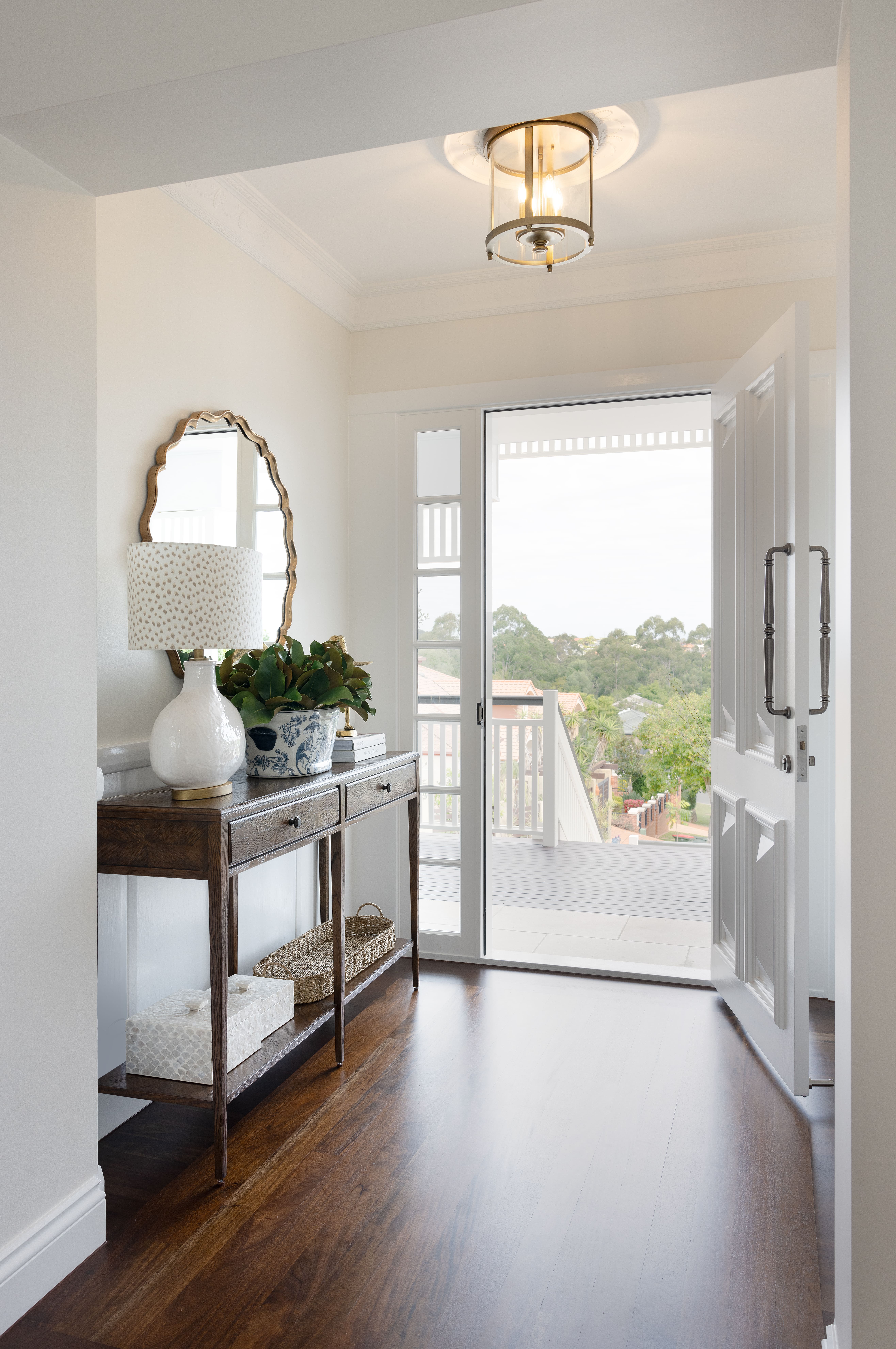 Entry hallway with hallway table and white walls and doors.