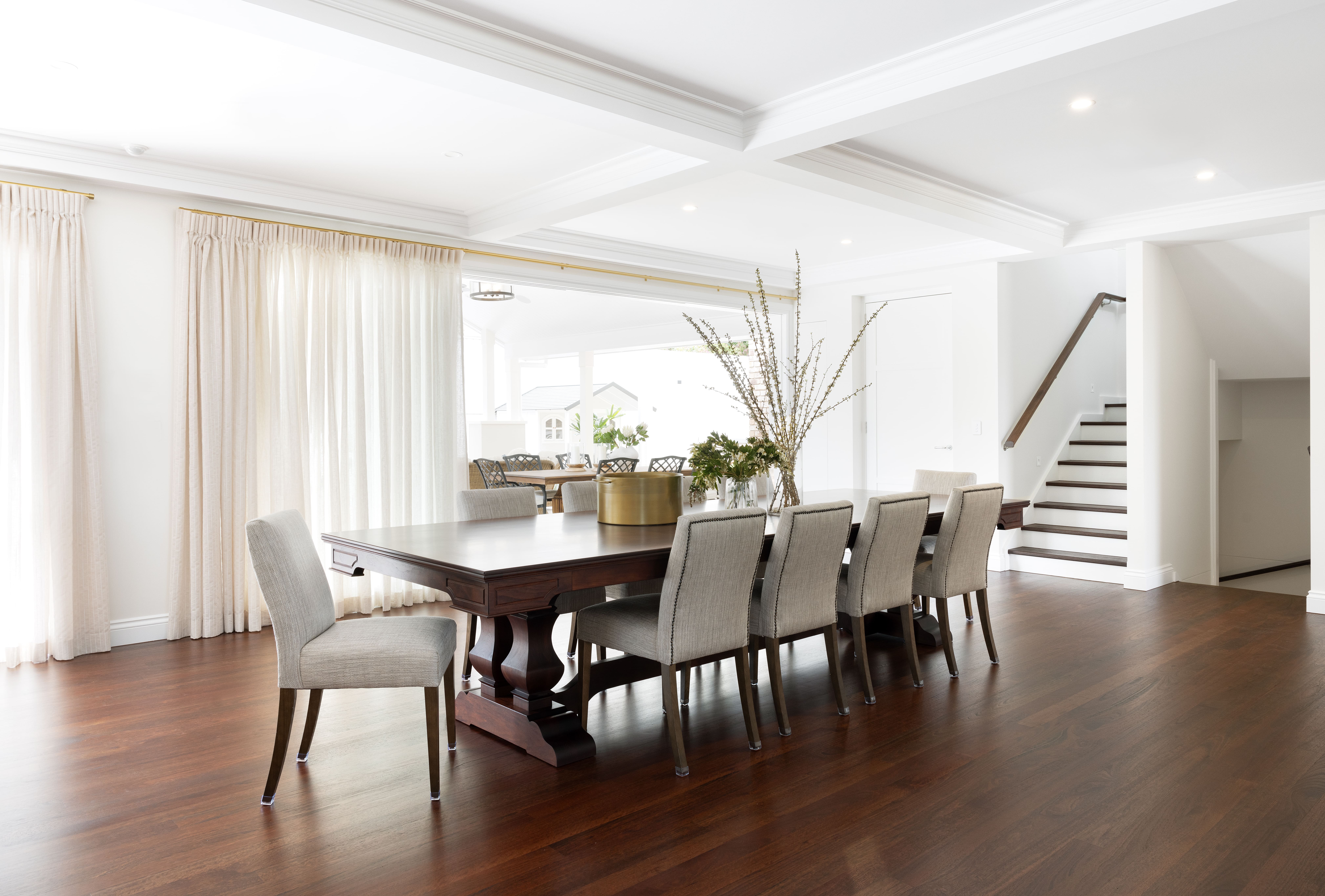 Dining area with white coffered ceilings and timber flooring