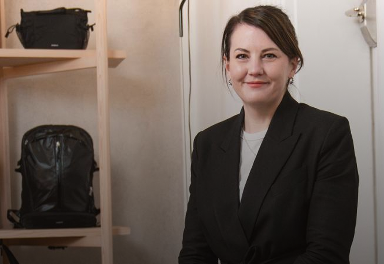 woman standing in front of a shelf with sanqvist backpacks
