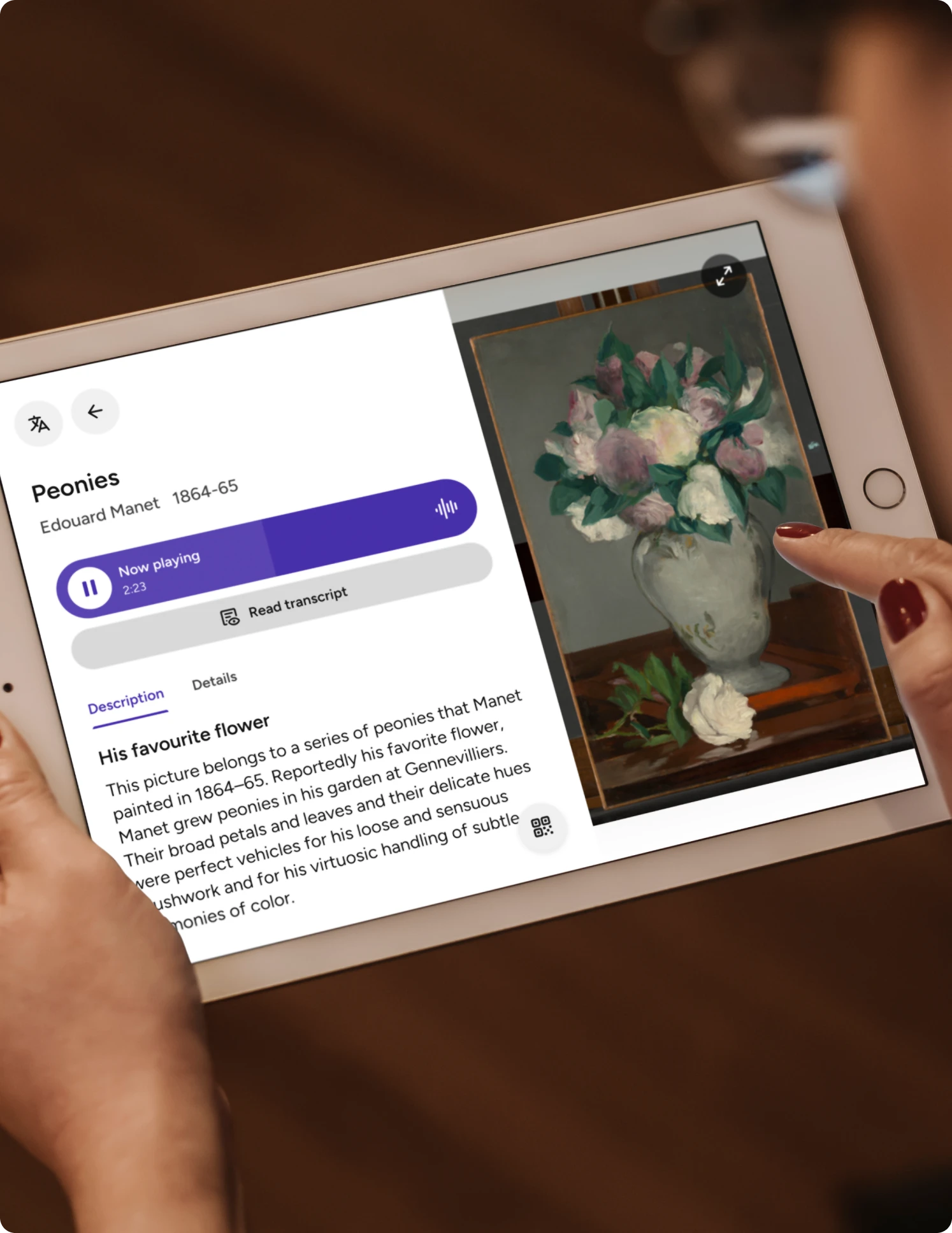 Visitor using a tablet with a digital label for Edouard Manet’s painting ‘Peonies,’ featuring artwork details, audio guide playback, and transcript options in a museum setting.