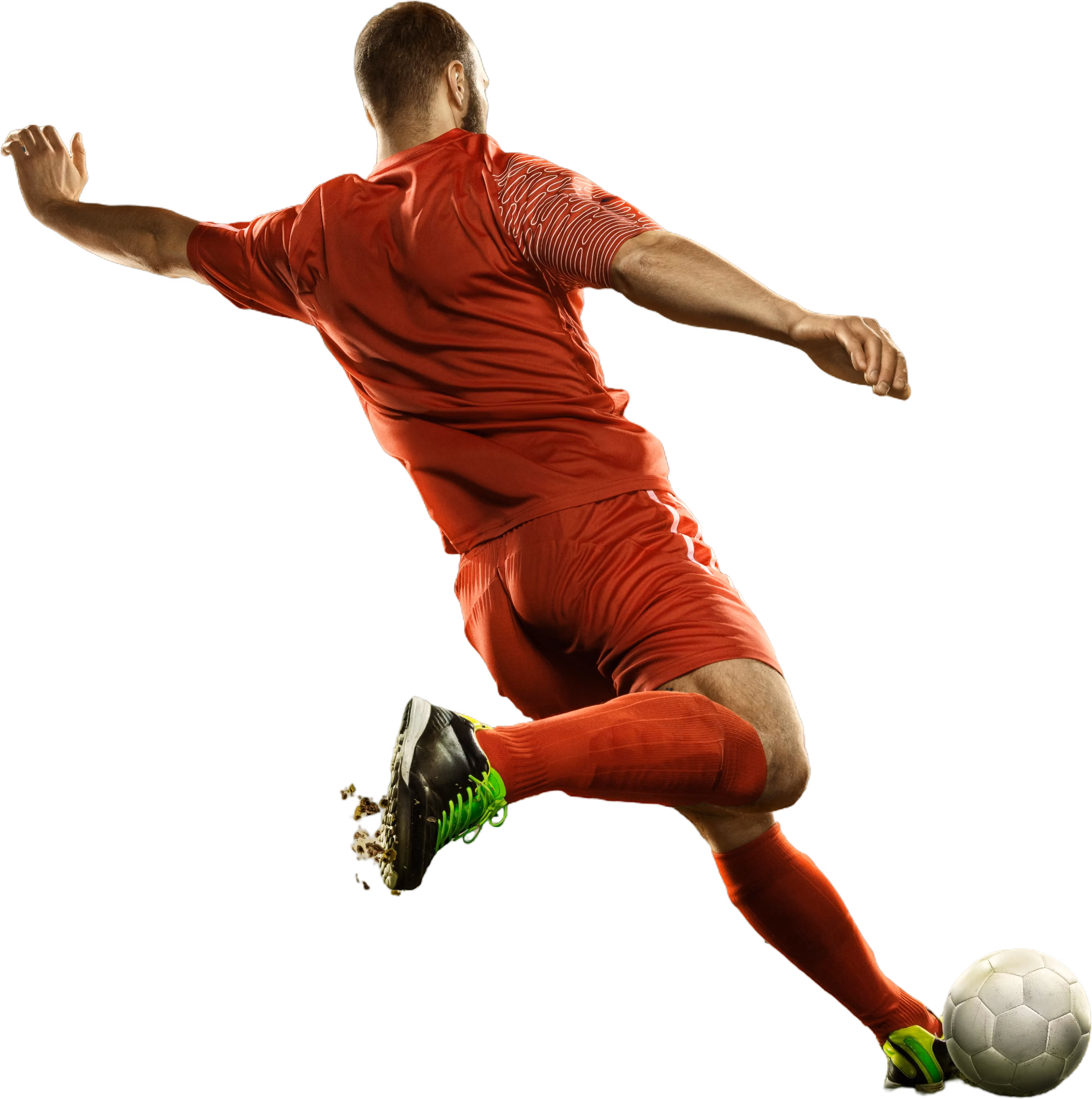 Soccer player in red uniform kicking a white soccer ball mid-air.