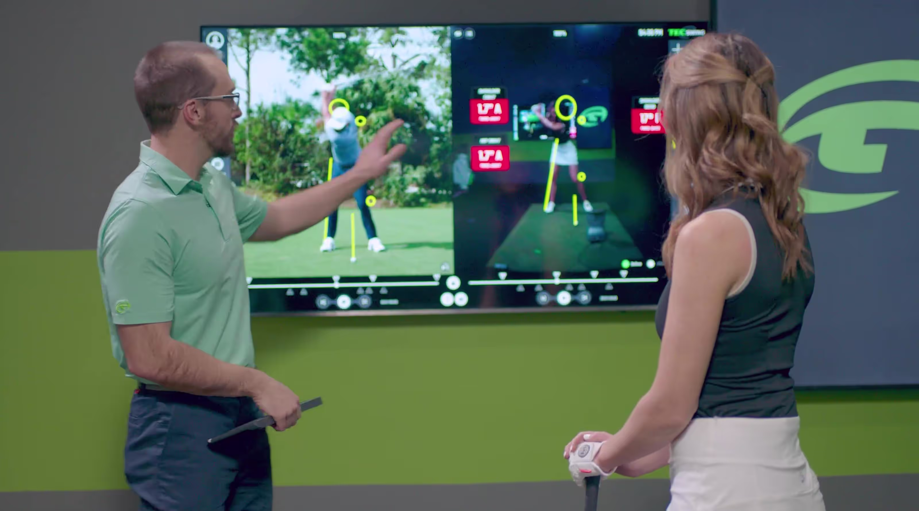 GOLFTEC Coach breaking down swing with OPTIMOTION technology for the student to better understand her swing. 