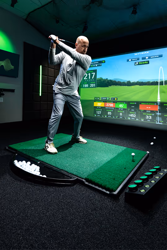Man Practicing in a GOLFTEC Bay