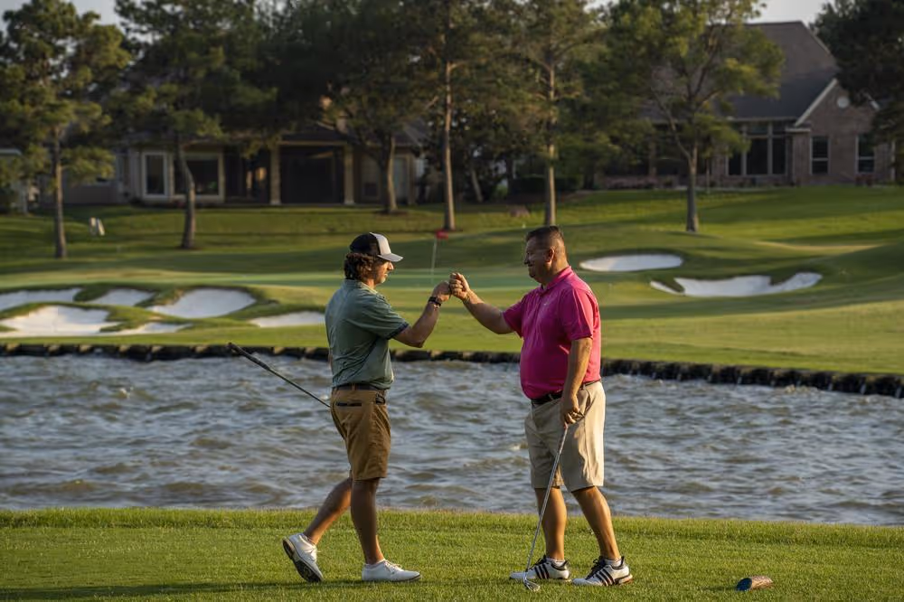 Golfer high five after making putt