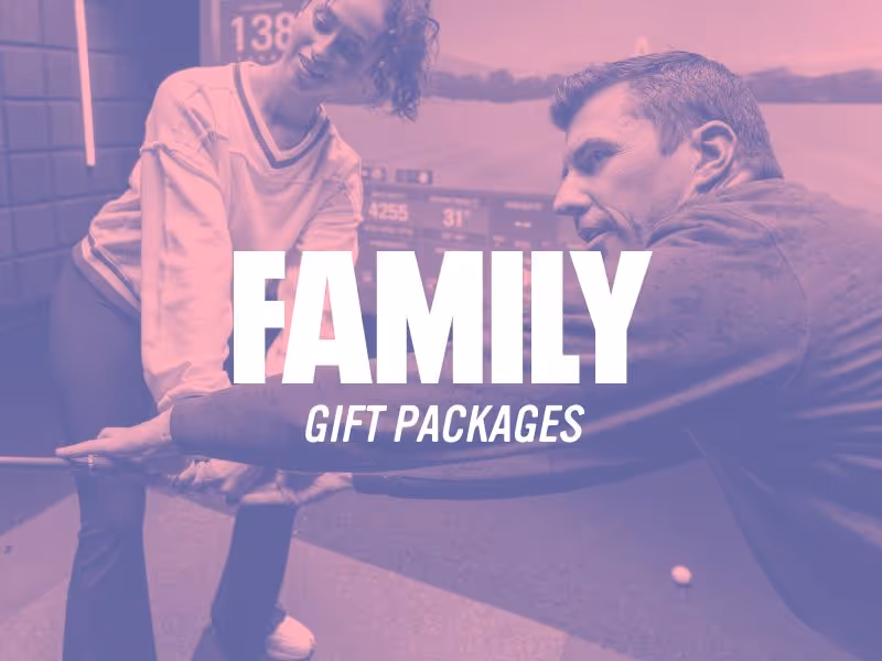 Man and woman smiling and holding hands at a golf simulator with text 'FAMILY GIFT PACKAGES' overlay.