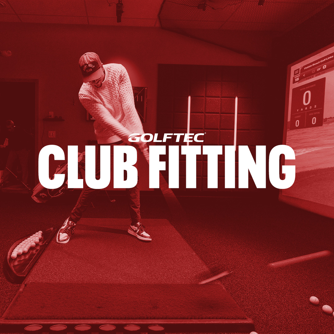 Person in a golf club fitting studio swinging a golf club with a screen tracking the shot in the background.