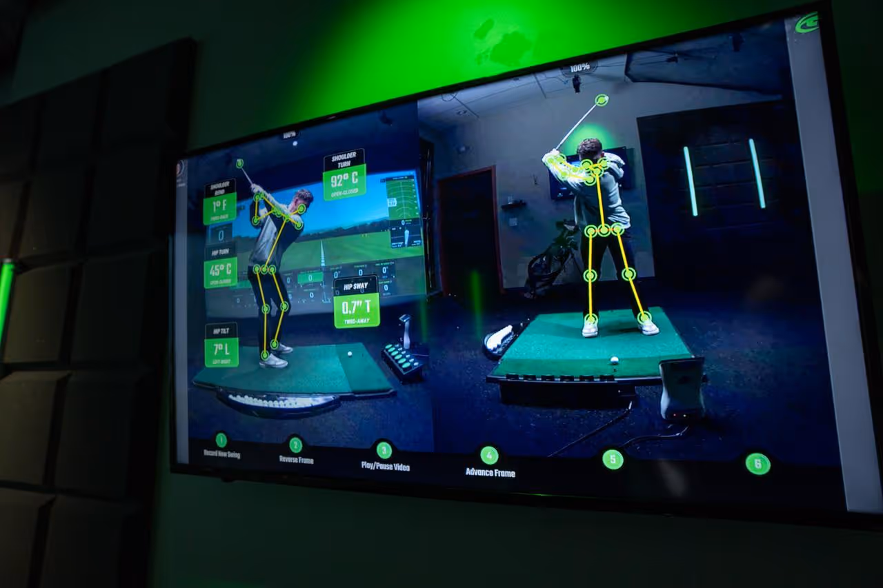 Screen showing a golf swing analysis with digital skeleton overlay and angle measurements on a golfer.