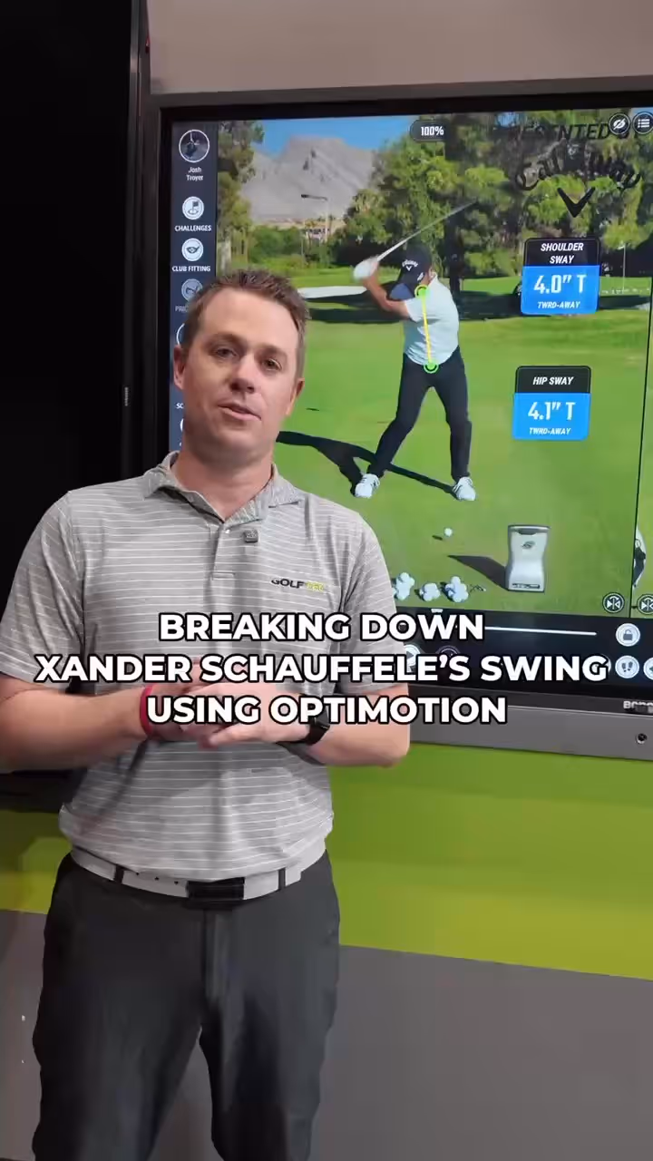 Man in a striped golf shirt explaining golf swing analysis with OptiMotion on a screen showing golfer Xander Schauffele's swing metrics.