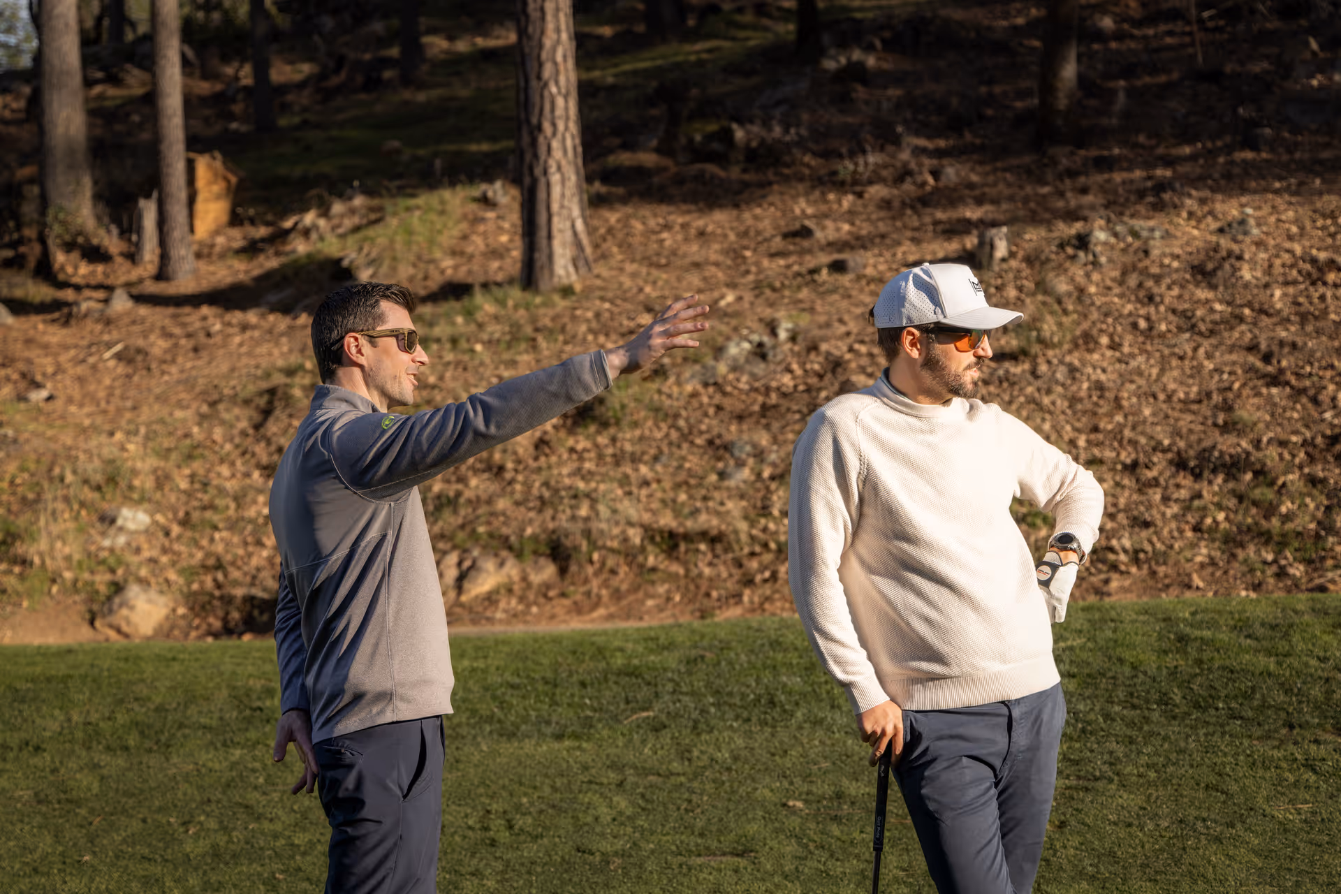 GOLFTEC Beginner Swing Evaluation showing a patient coach providing real time feedback to a new golfer in a private hitting bay.