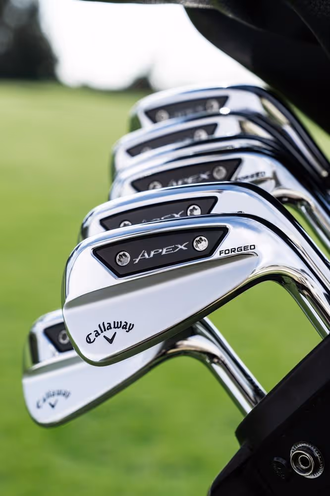 Close-up of Callaway irons in club bag with grassy background