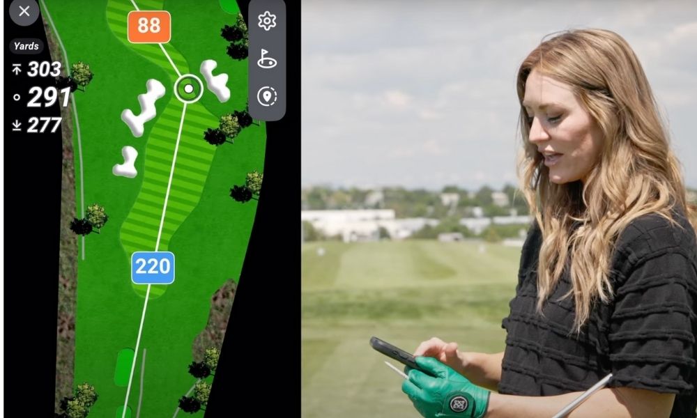Mariah checking her GOLFTEC App for yardage information