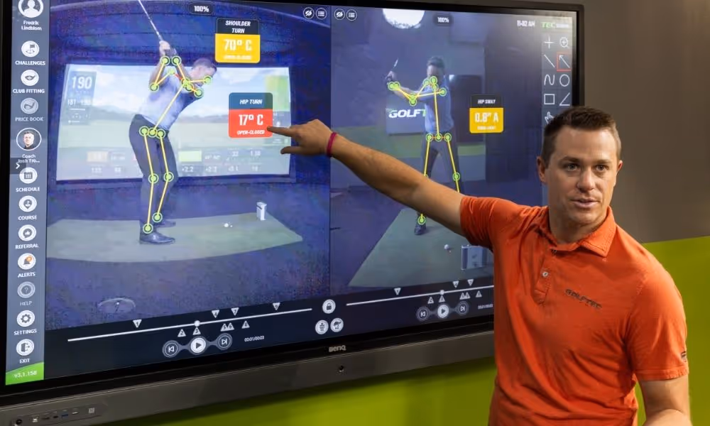 GOLFTEC Coach pointing at OPTIMOTION technology