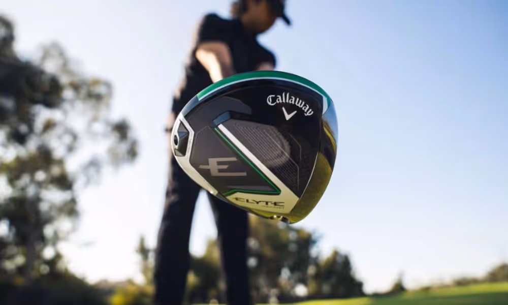 Close-up of a Callaway Elyte driver head with a golfer preparing to swing in the background