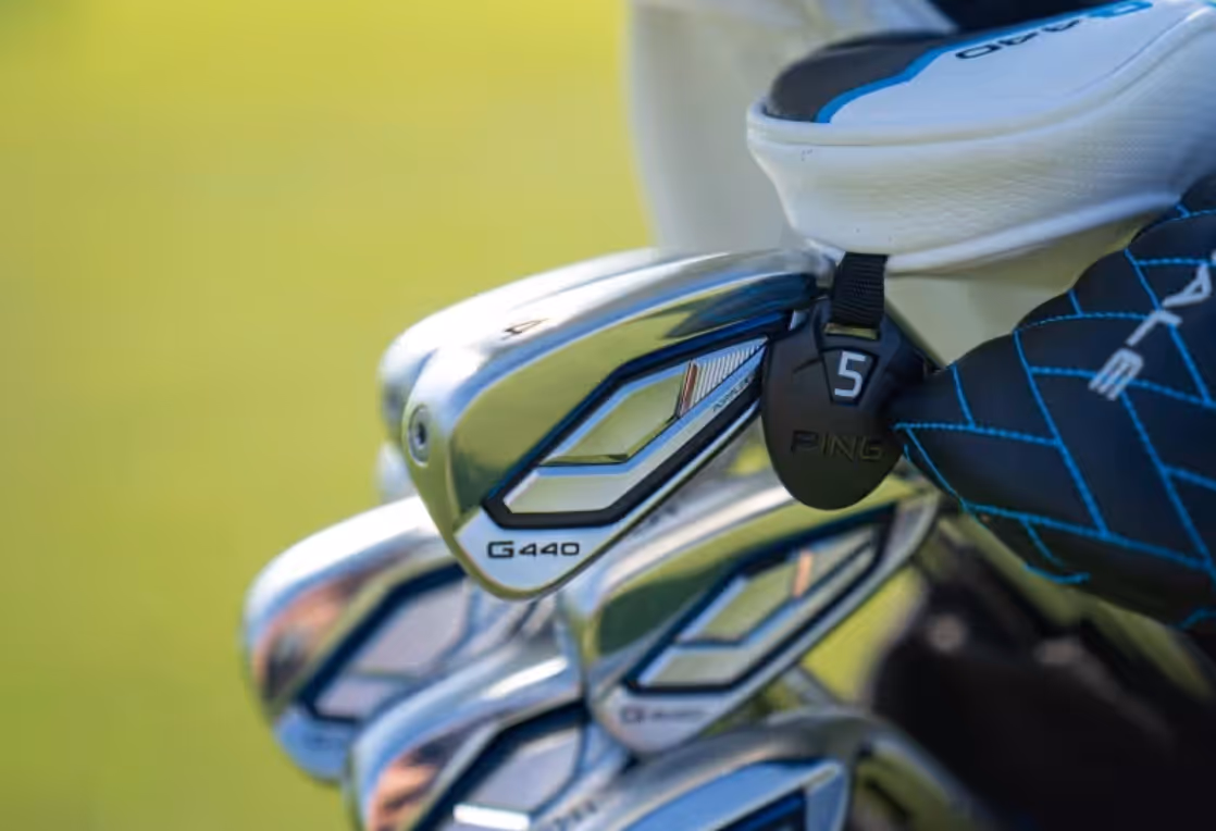 Close-up of PING G430 irons in a golf bag on the course