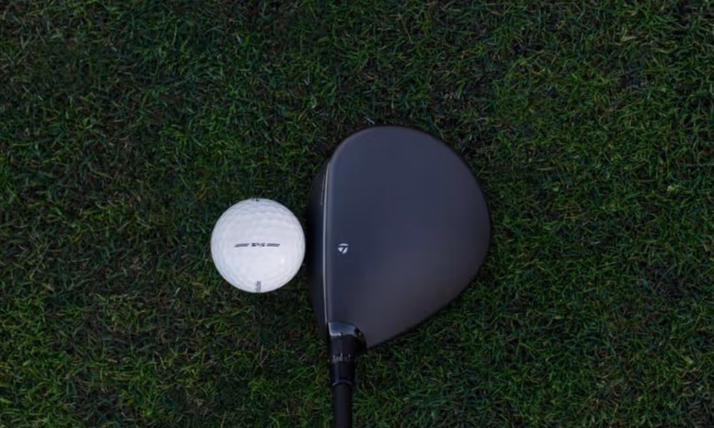 TaylorMade Qi4D Fairway Wood next to ball on grass