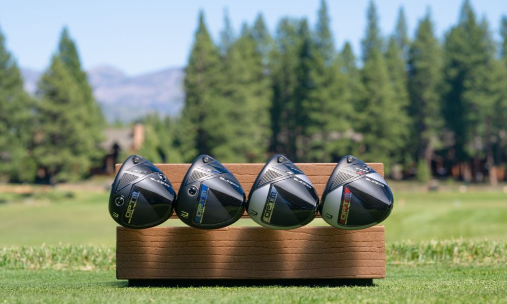 four Cobra OPTM drivers on a bench with course in background