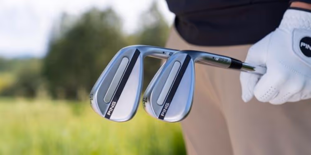 golfer holding two PING s259 wedges on the course