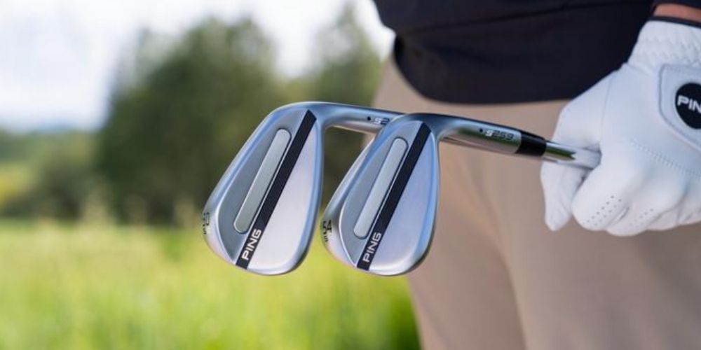 golfer holding two PING s259 wedges on the course
