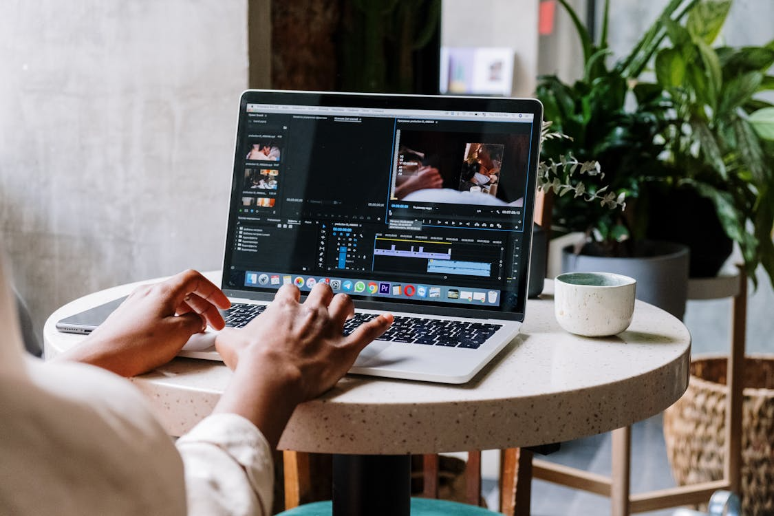  person using macbook pro on white table