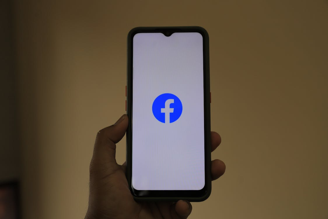  person holding black and white smartphone case 