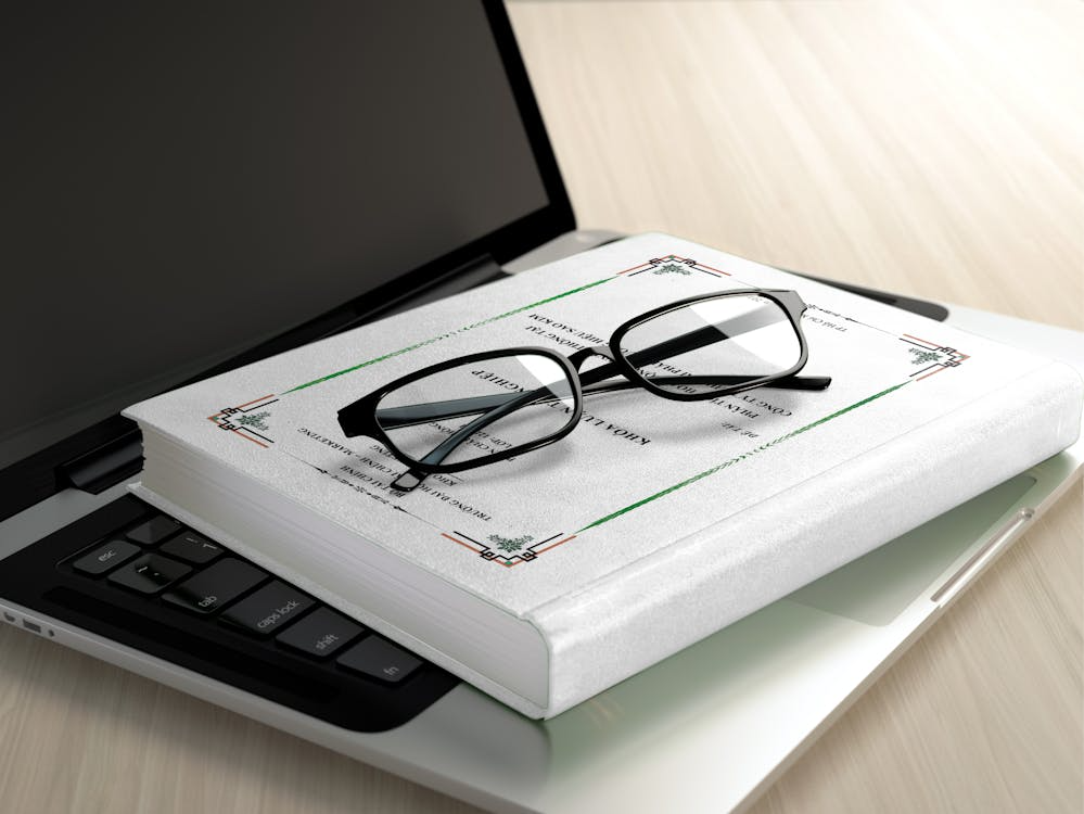 black frame eyeglasses on white book