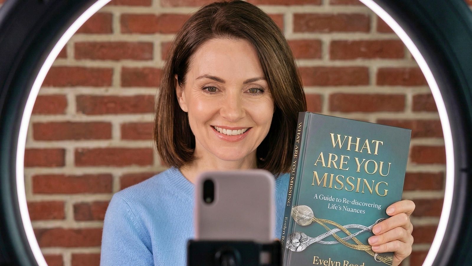 woman holding her book in front of her phone
