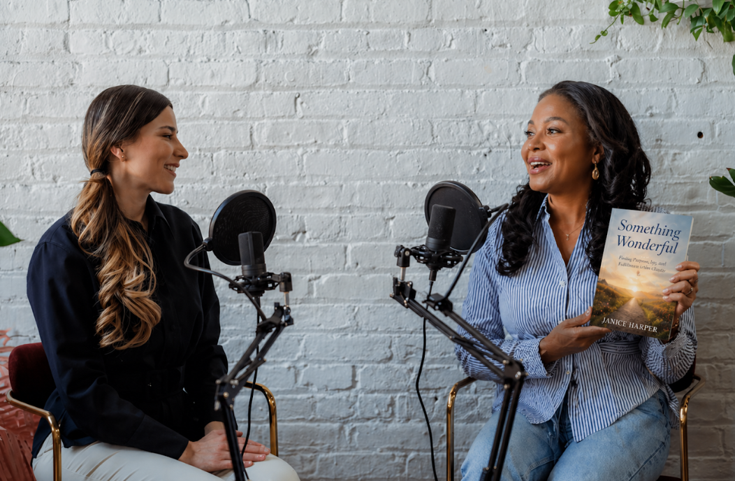 Author speaking into a podcast microphone during an interview