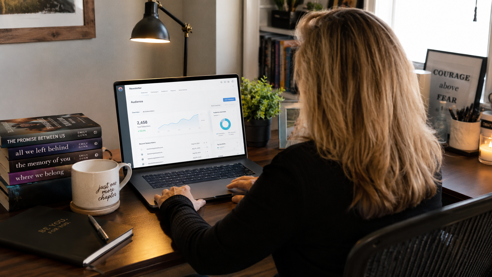 Woman in her 40s reviewing email newsletter signups on a laptop at a home office desk