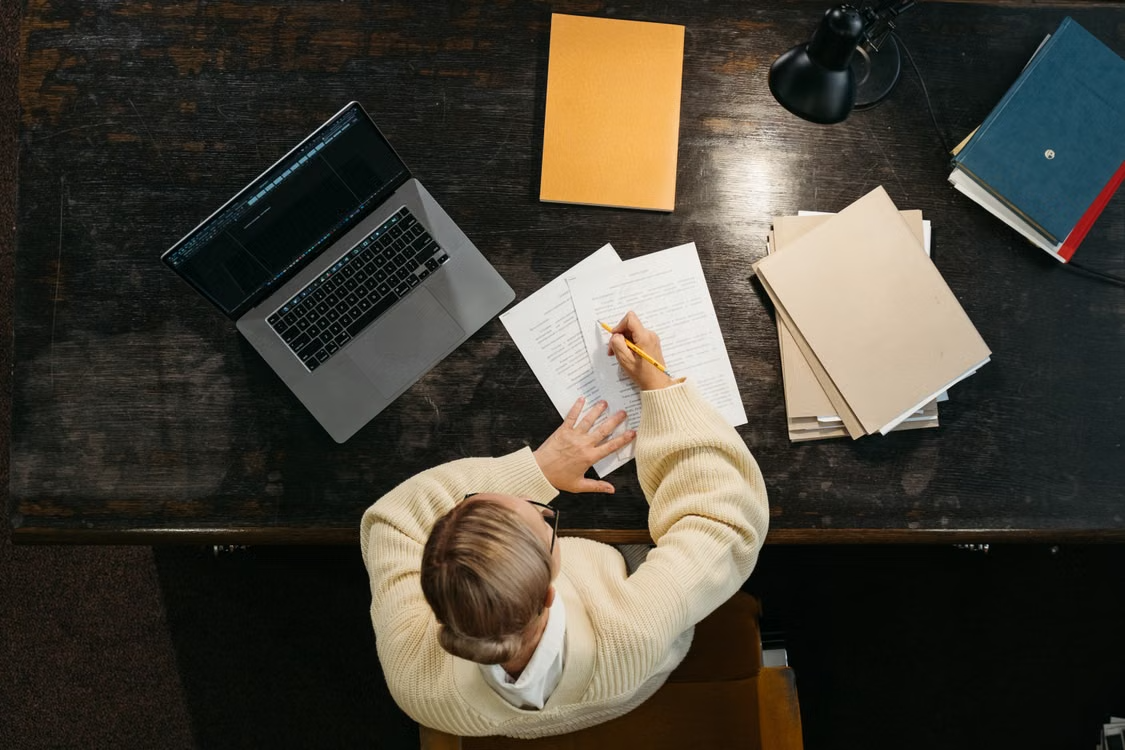 Author planning a book launch marketing strategy at a desk.