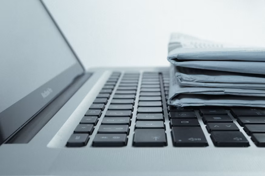 Published author writing a newsletter alongside their books
