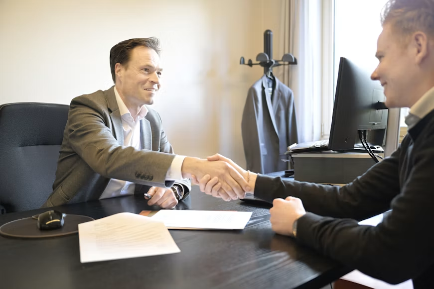Writer and brand representative shaking hands on a sponsorship partnership