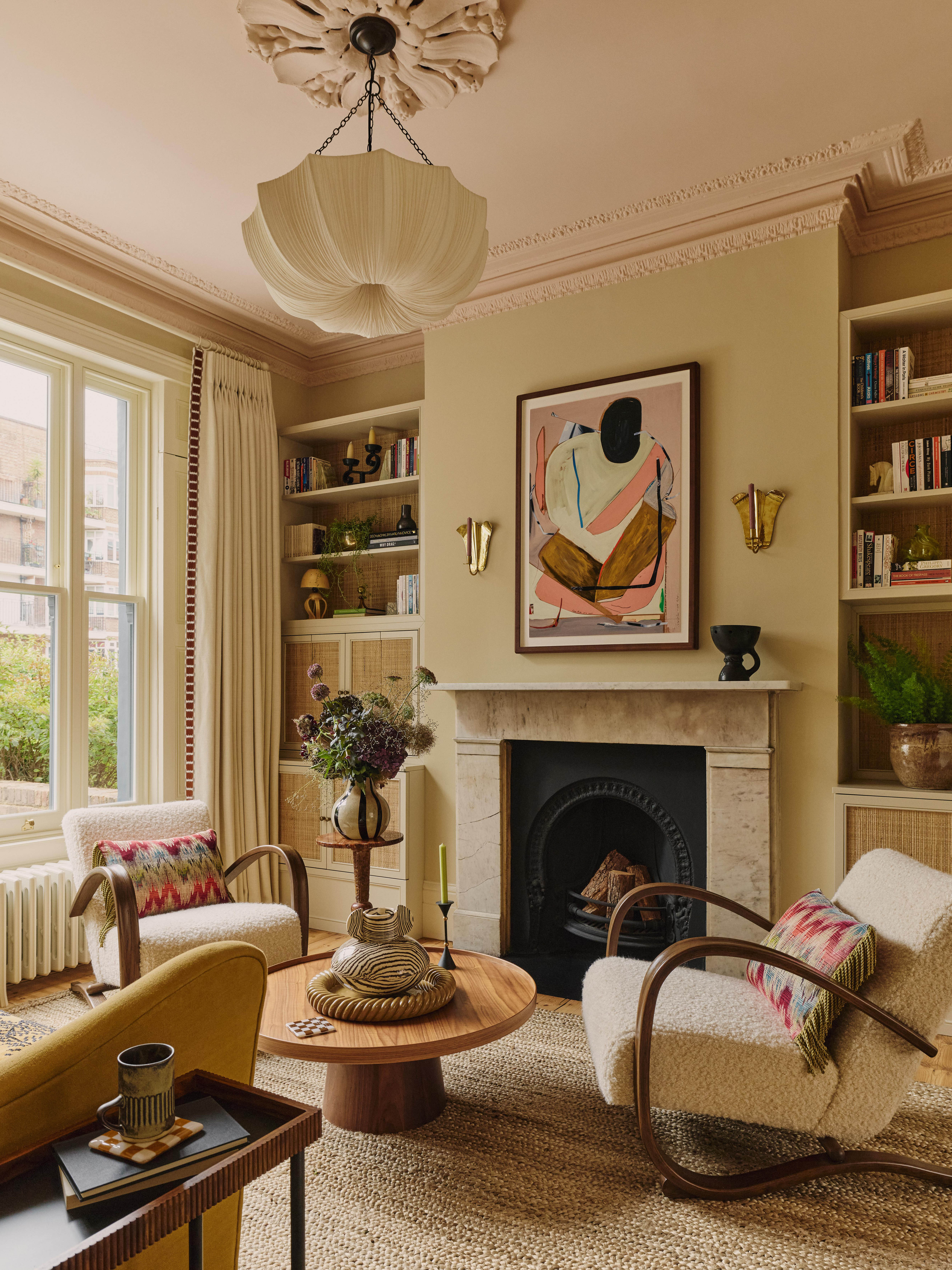 Fresh interior sitting room with pale pink sofa, burl side tables and acid bright yellow doors