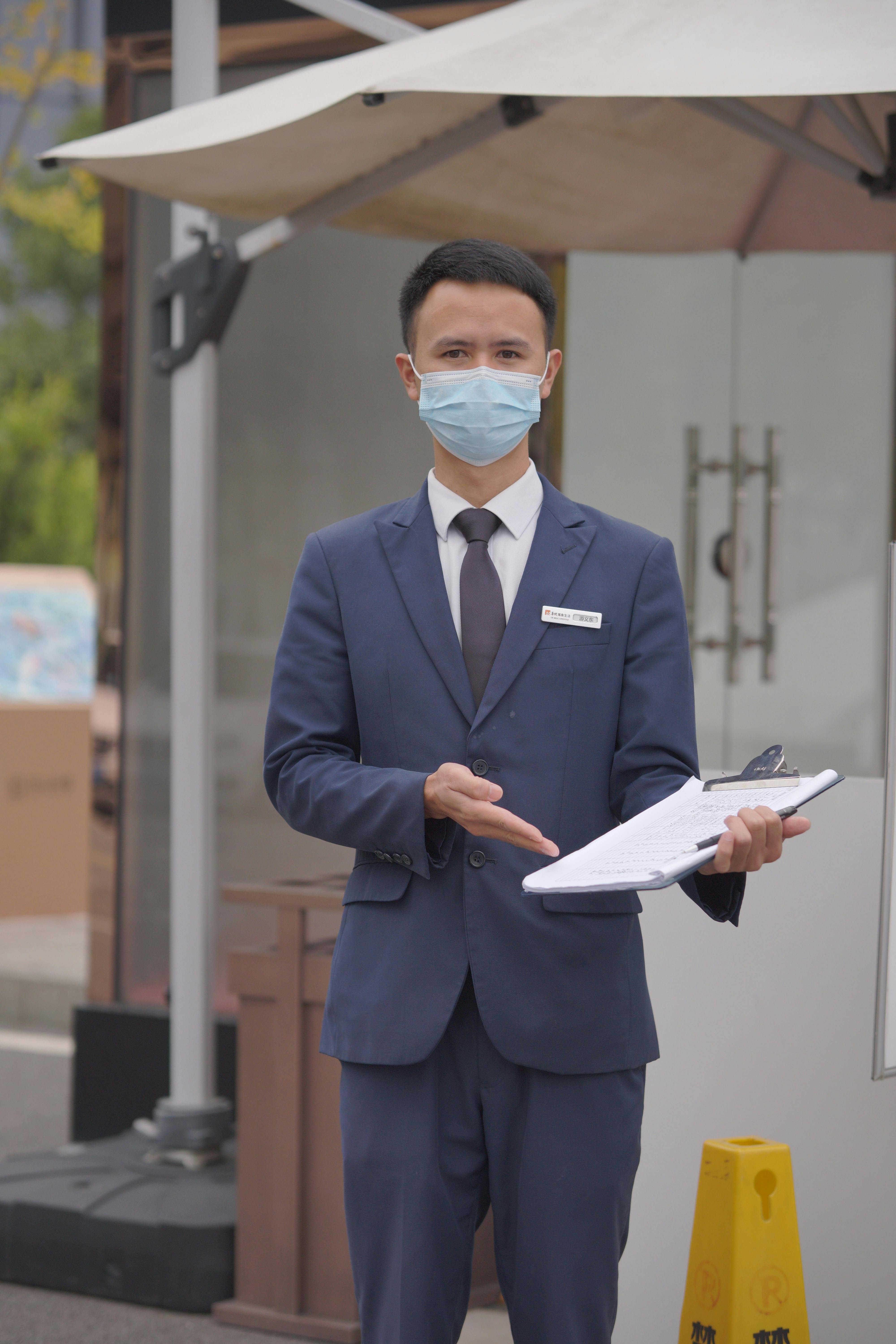 Man in suit wearing a face mask, holding a clipboard outdoors. Ideal for business and health-related content.