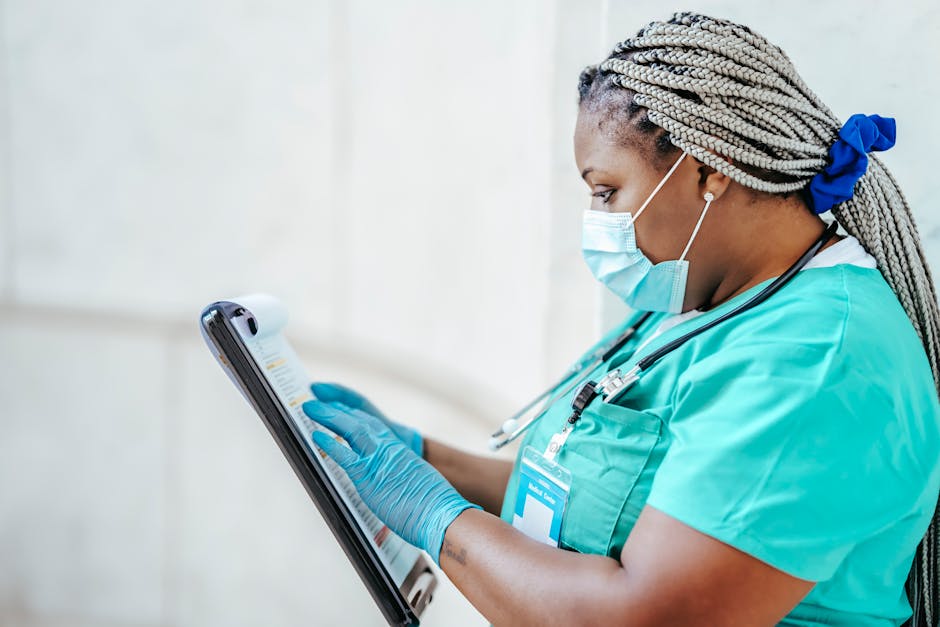 Healthcare worker attentively reviewing medical documents indoors.