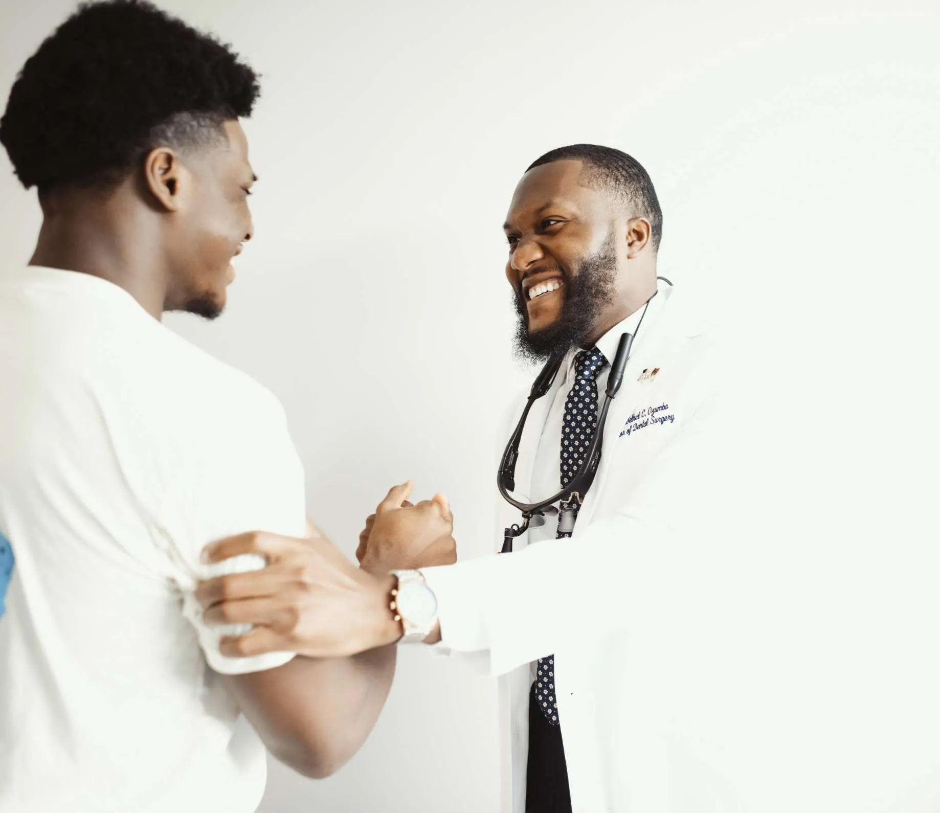 Dr. Ozumba smiling with a male patient