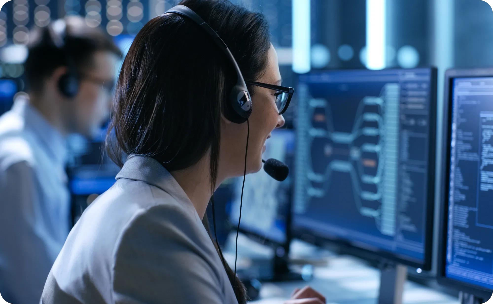 A man working as a tech support employee with woman coworker in the background