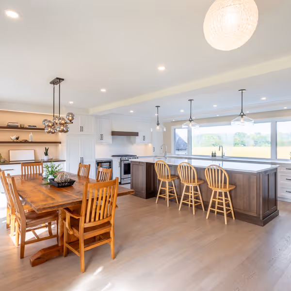 Modern kitchen counter with coffee machine, white cups, a tray with cream and sugar containers, and shelves above holding cups, a coffee grinder, tulips in a vase, and decorative jars.