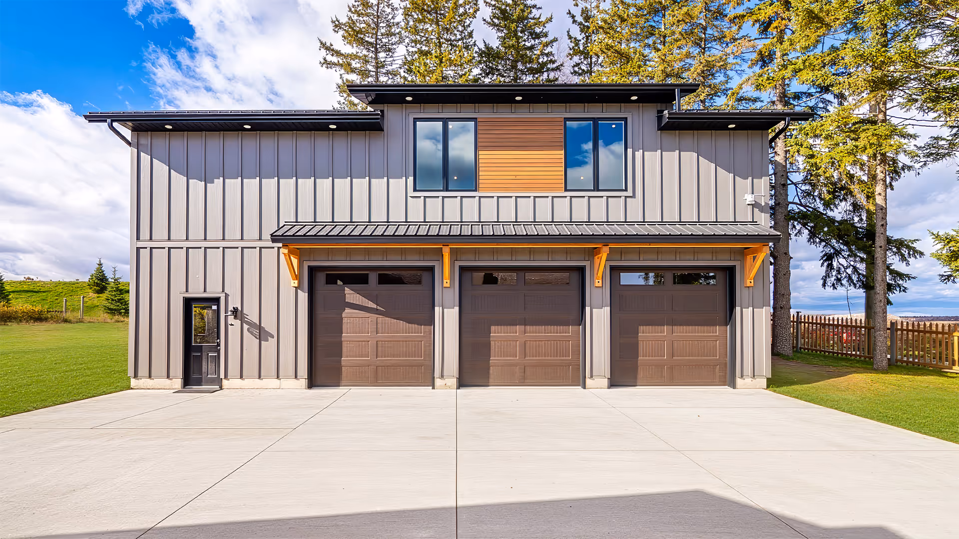 Modern white kitchen with stainless steel refrigerator, built-in microwave and oven, white countertops, and wooden flooring with a light gray rug.