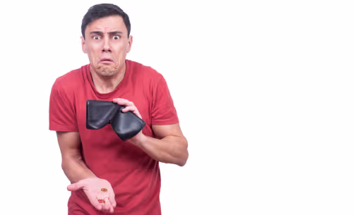 A worried person holds an empty wallet and a few coins, illustrating the financial burden of expenses such as DUI fines and court costs.