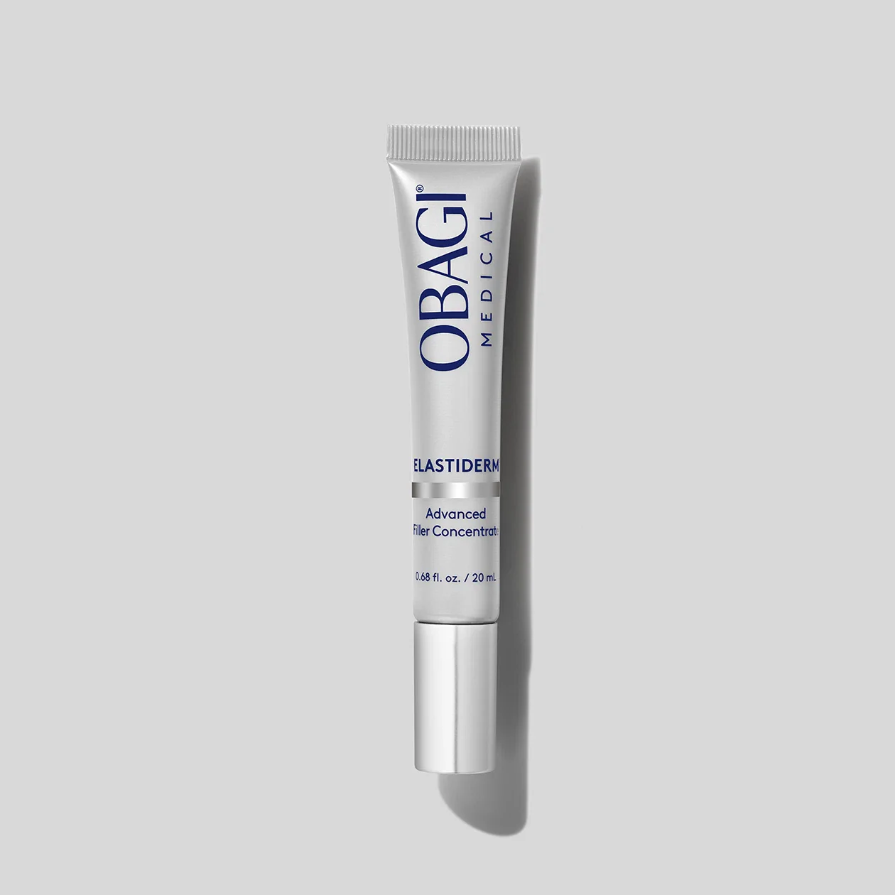 Silver tube of OBAGI Medical ELASTIDERM Advanced Filler Concentrate on a gray background.