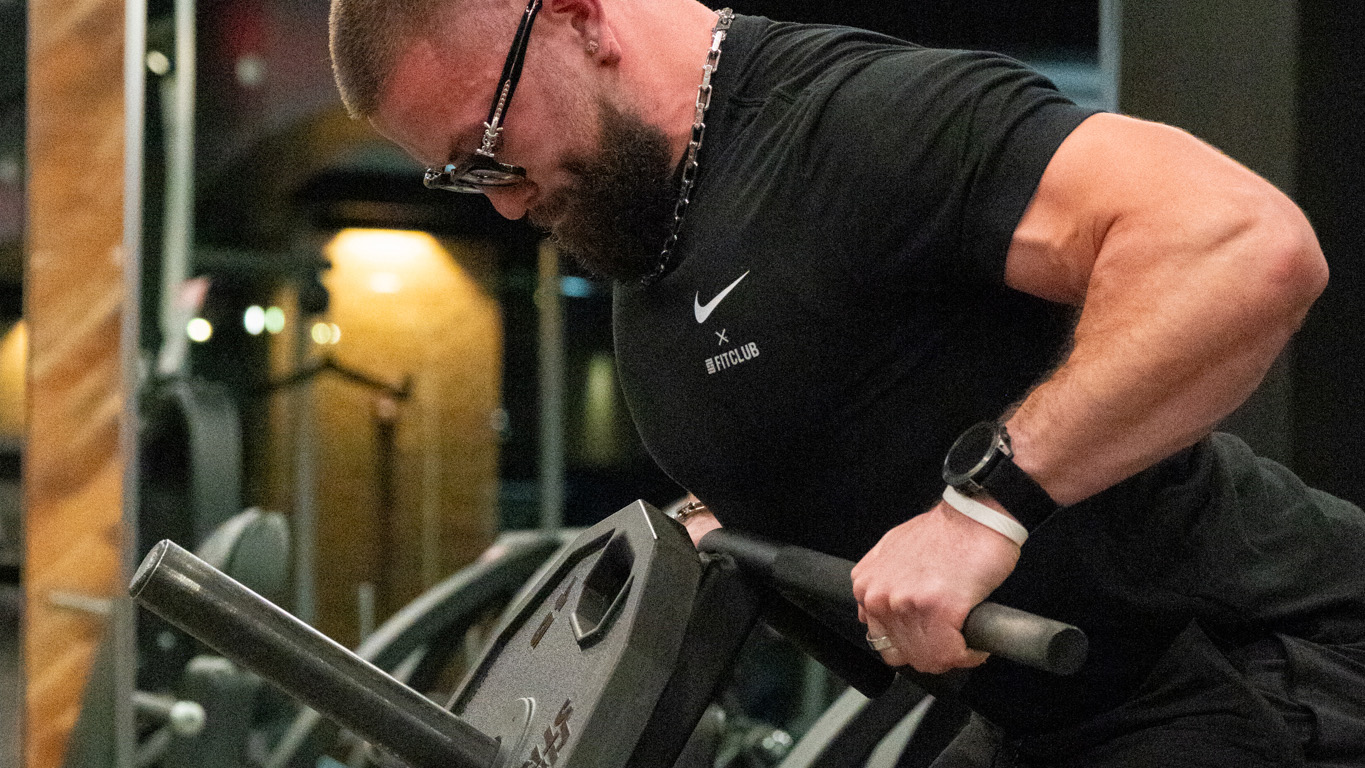 Jeremy performing back exercise using t-bar machine