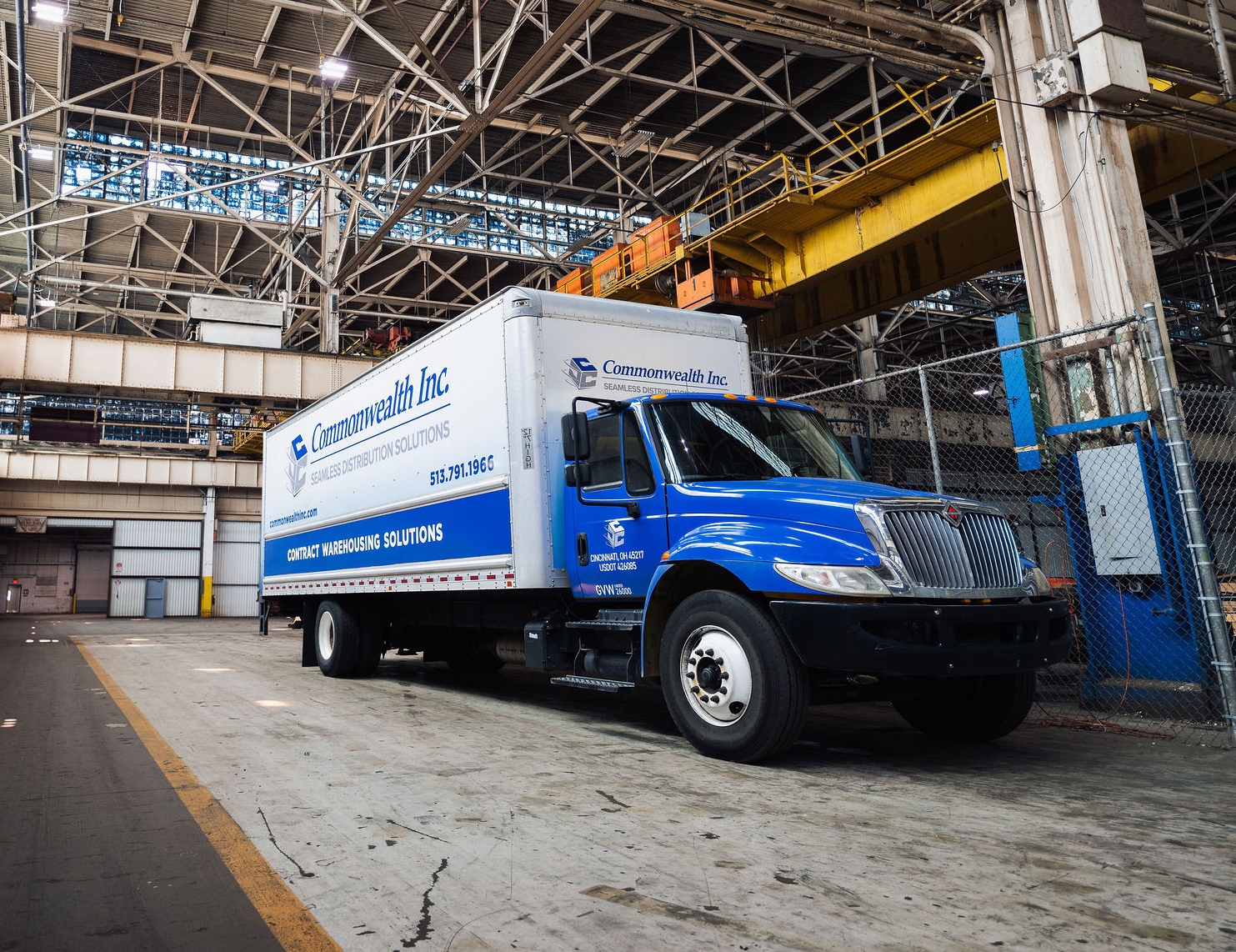 Forklift passing through pallet racks