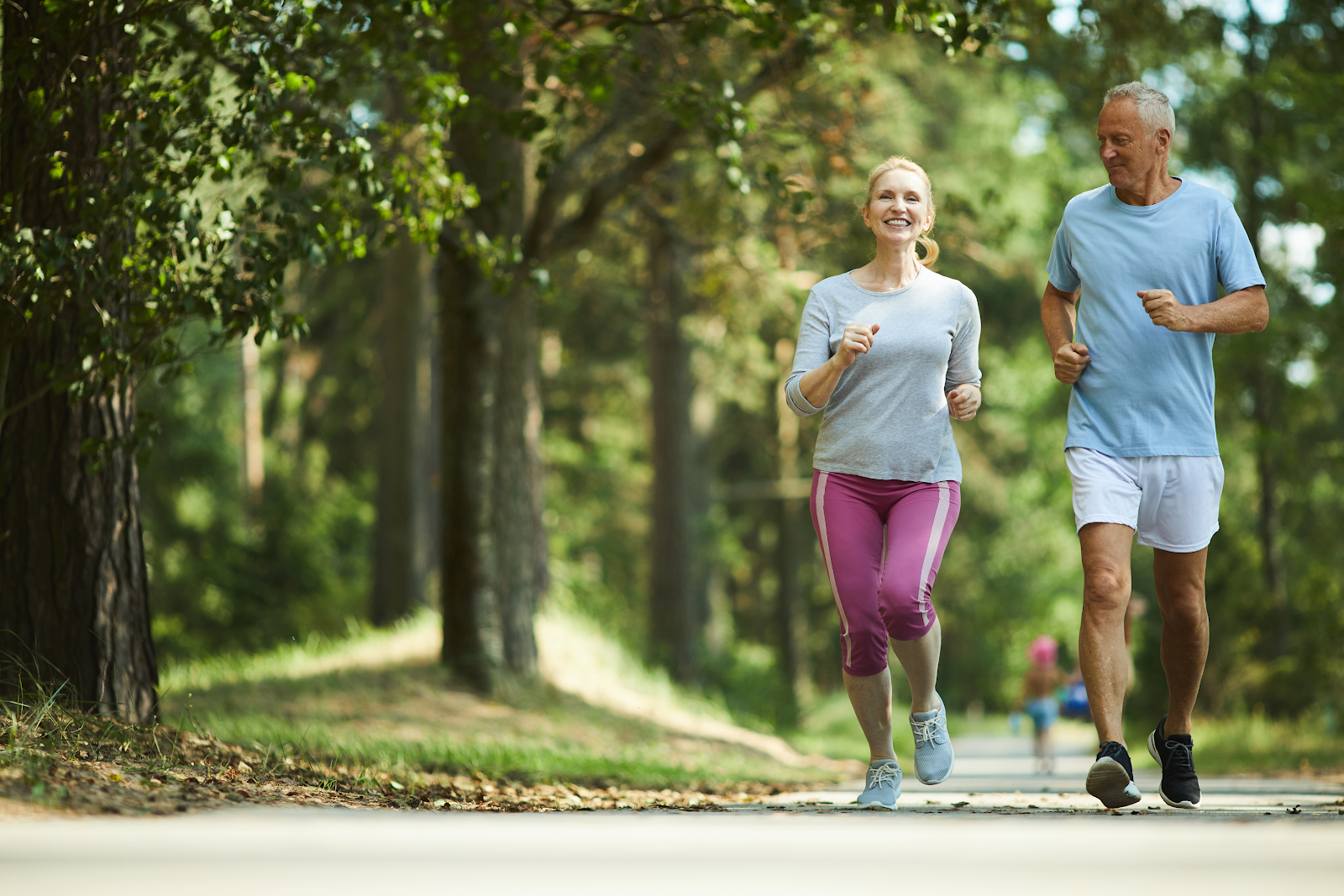 A person and person running on a pathAI-generated content may be incorrect.